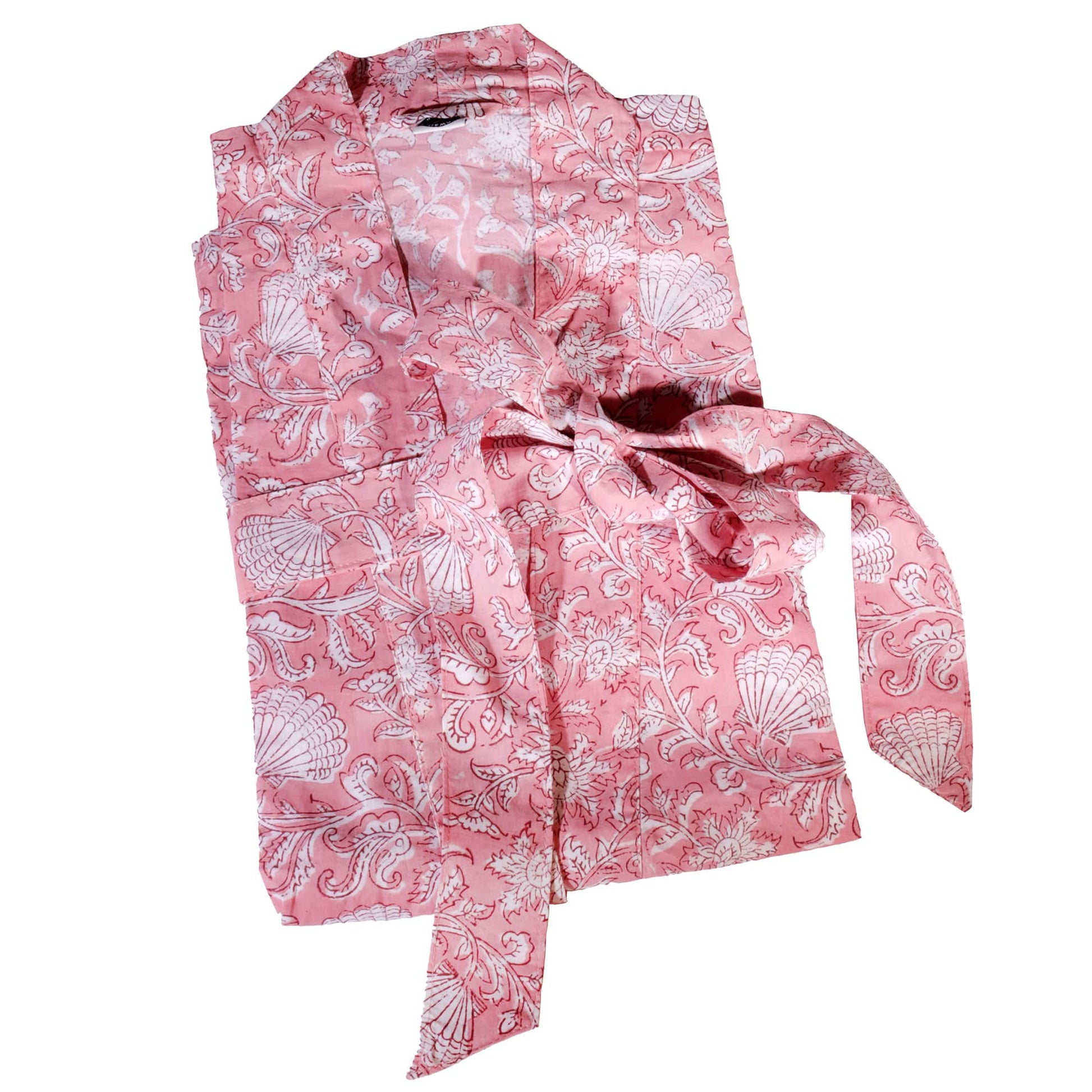 A folded pink dressing gown featuring an elegant white block print design of intricate floral and seashell patterns. The robe is tied neatly with a matching fabric belt, showcasing its soft and lightweight texture.