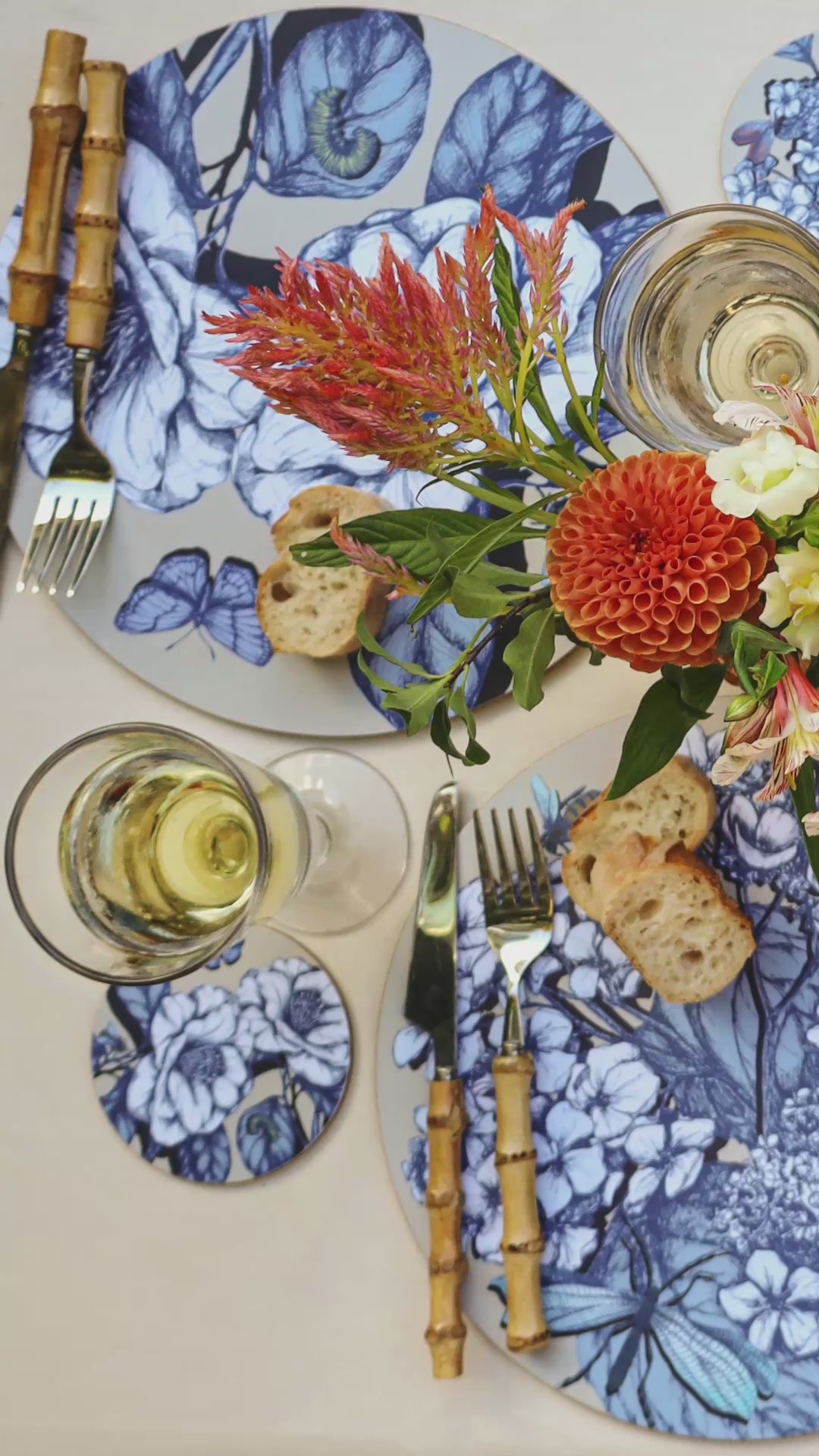 video of explorers garden placemats paid out on table with flowers and cutlery.