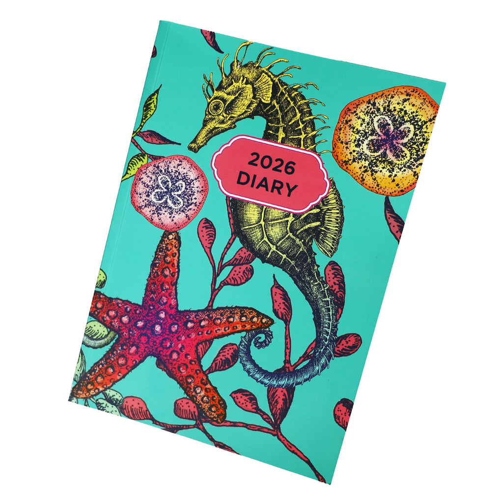 Cream Cornwall 2026 diary with colourful reef-inspired cover featuring seahorse, starfish and coral illustration.