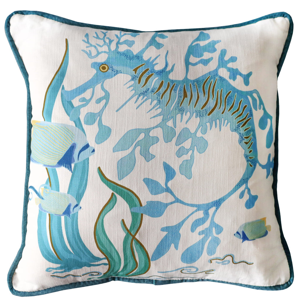 Cream Cornwall Sea Dragon cushion featuring a hand-illustrated sea horse, fish and seaweed design in soft blue and turquoise tones with contrasting velvet piping.