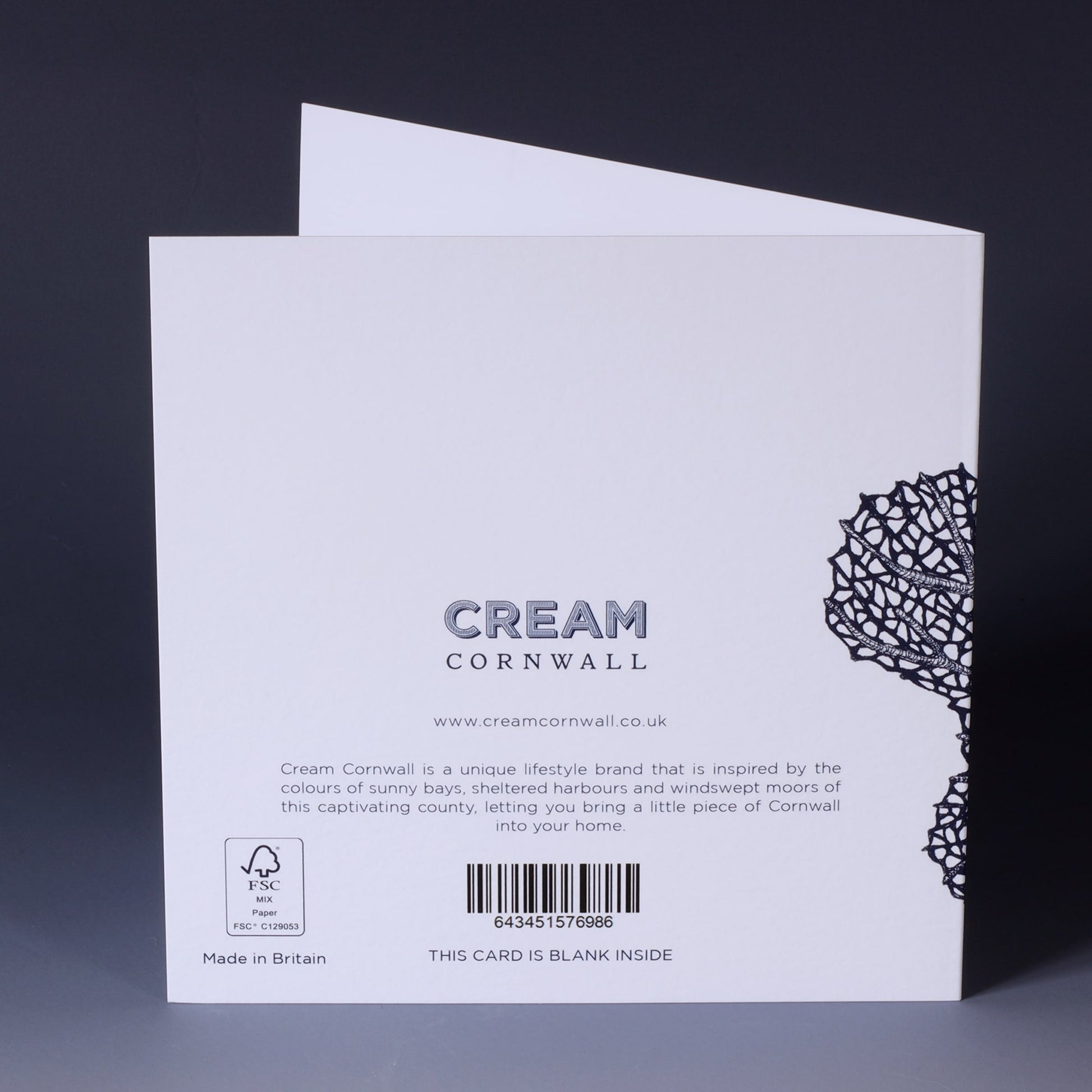 back of greeting card with navy illustration of a sea fan on a white background