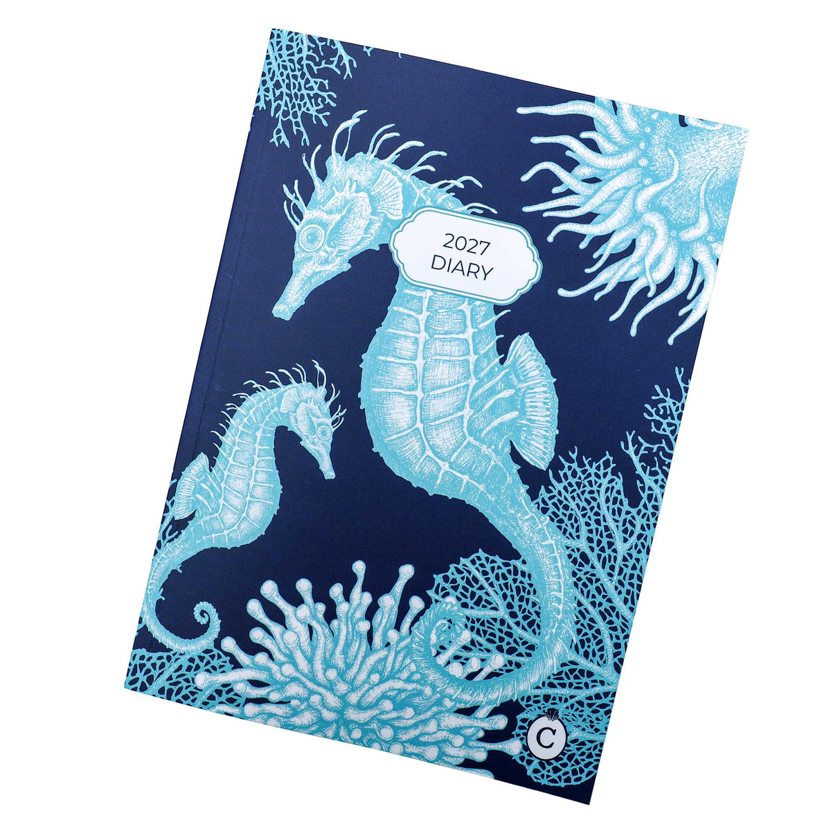 2027 diary flay lay with navy background and turquoise seahorse and corals decorating it.