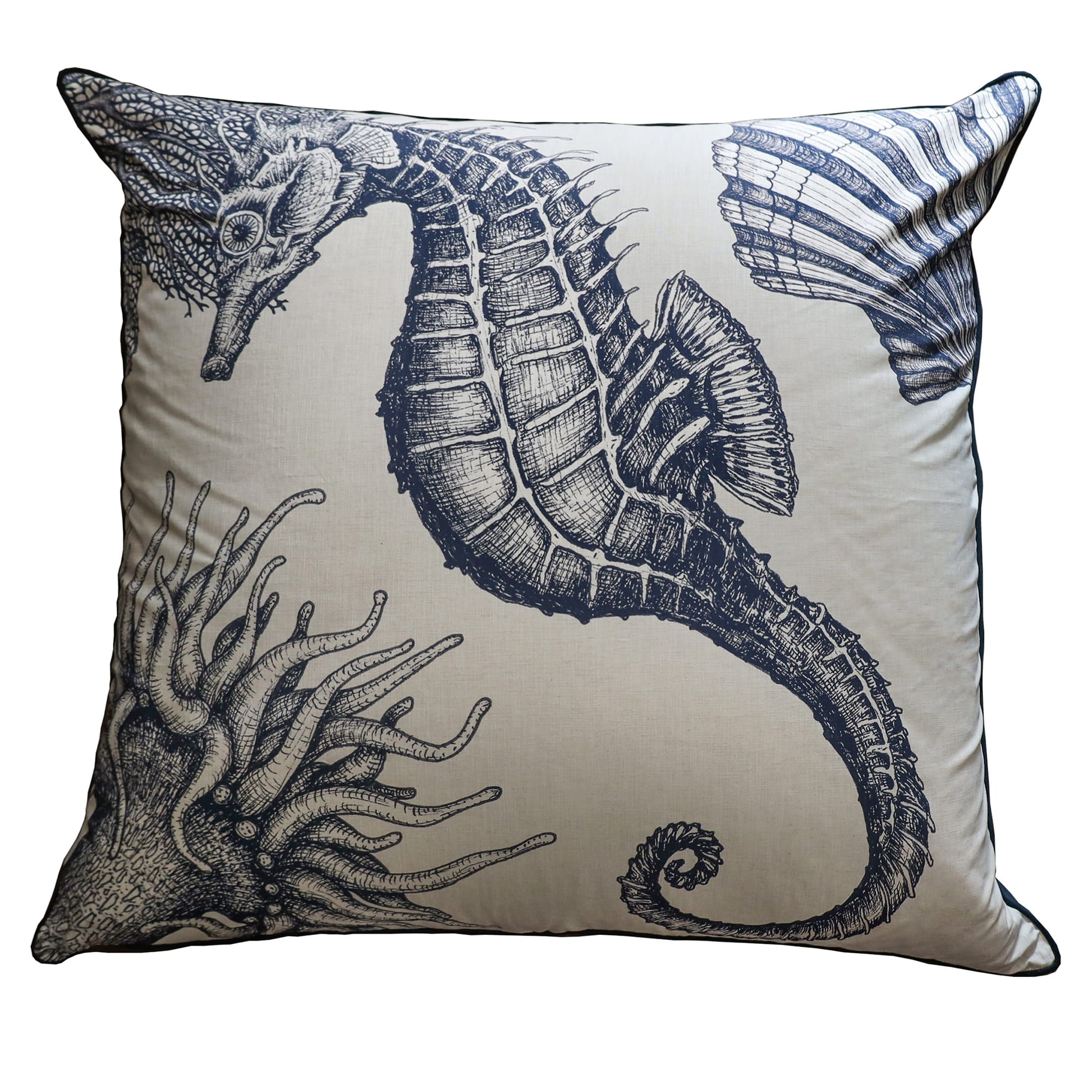Decorative pillow with a seahorse design on a beige background