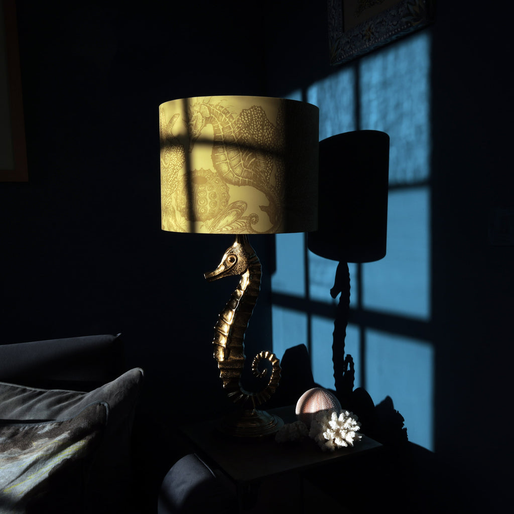Decorative lamp with seahorse design on a dark background