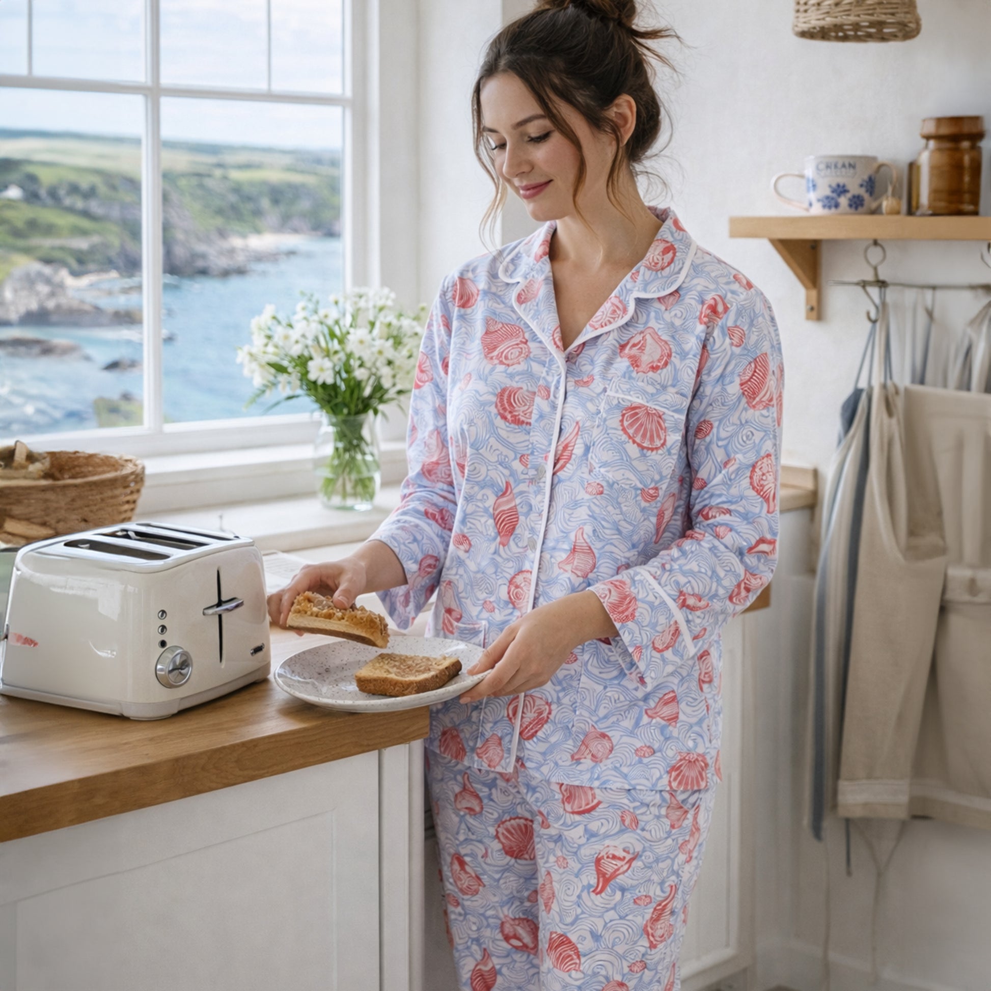Woman in a kitchen wearing a floral pajama set, preparing food.