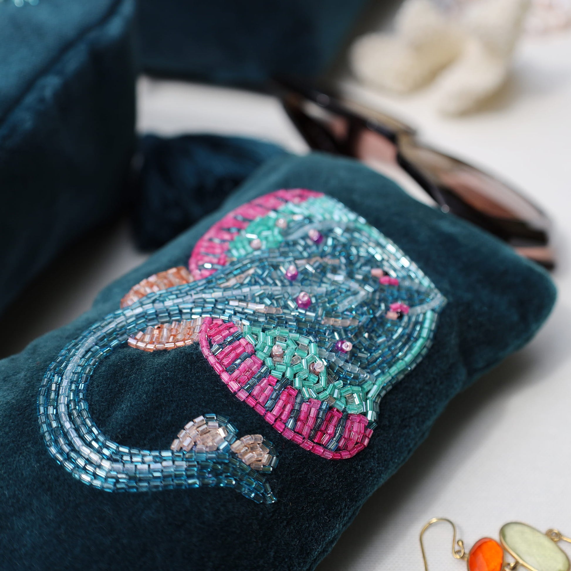 Decorative phone case with beaded skate design on a white surface