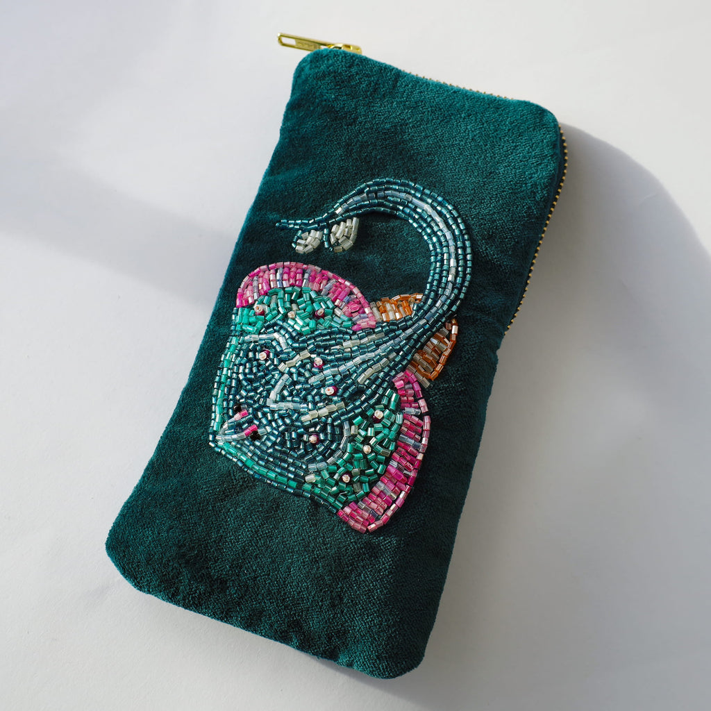 Teal pouch with beaded skate design on a white background