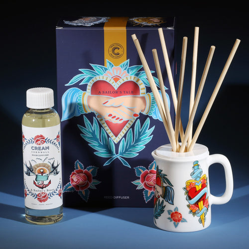 Sailors Story room diffuser with natural reeds in front of the product box and a bottle of diffuser liquid.