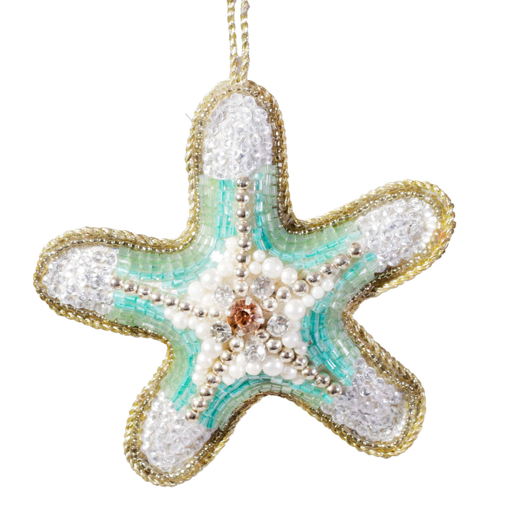 A beaded starfish decoration with turquoise, white, and gold detailing, featuring pearl and crystal accents and a gold hanging thread.