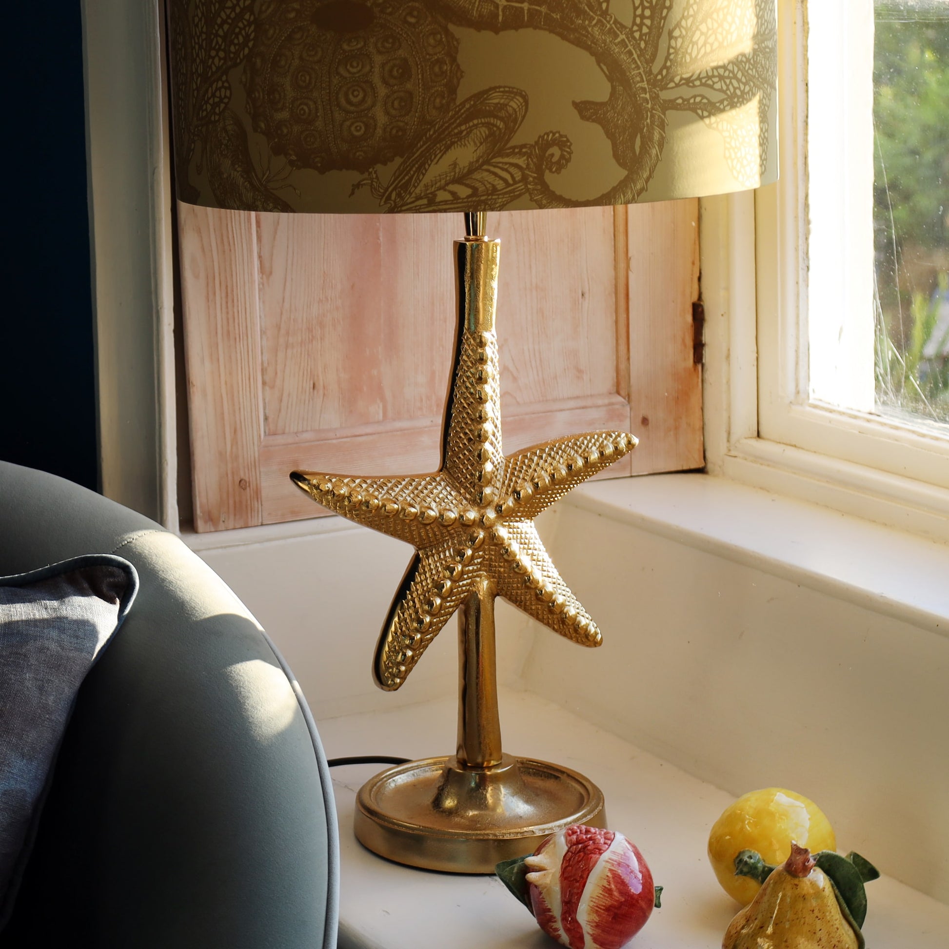 Decorative lamp with starfish design on a windowsill
