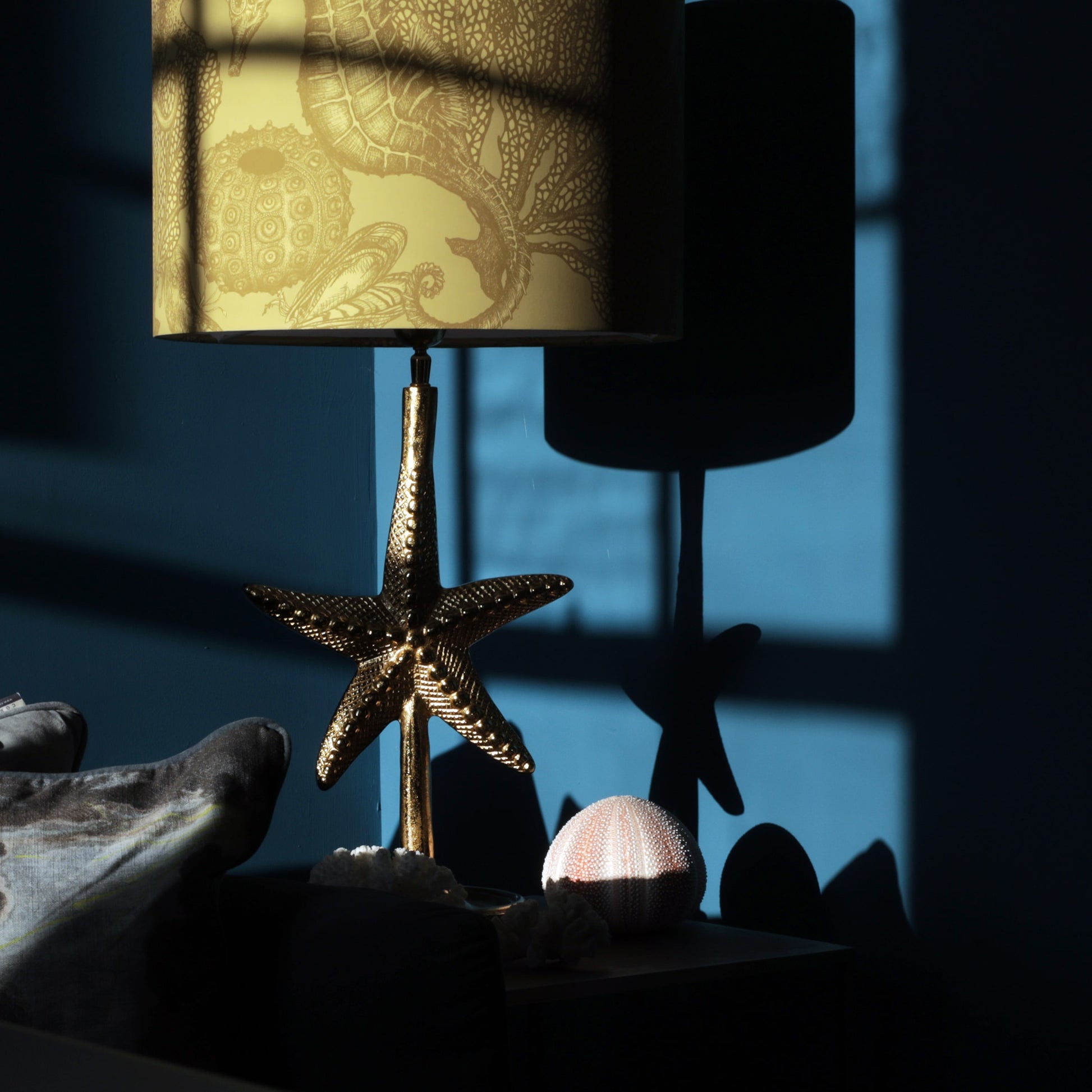 Decorative gold lamp with starfish design on a dark background
