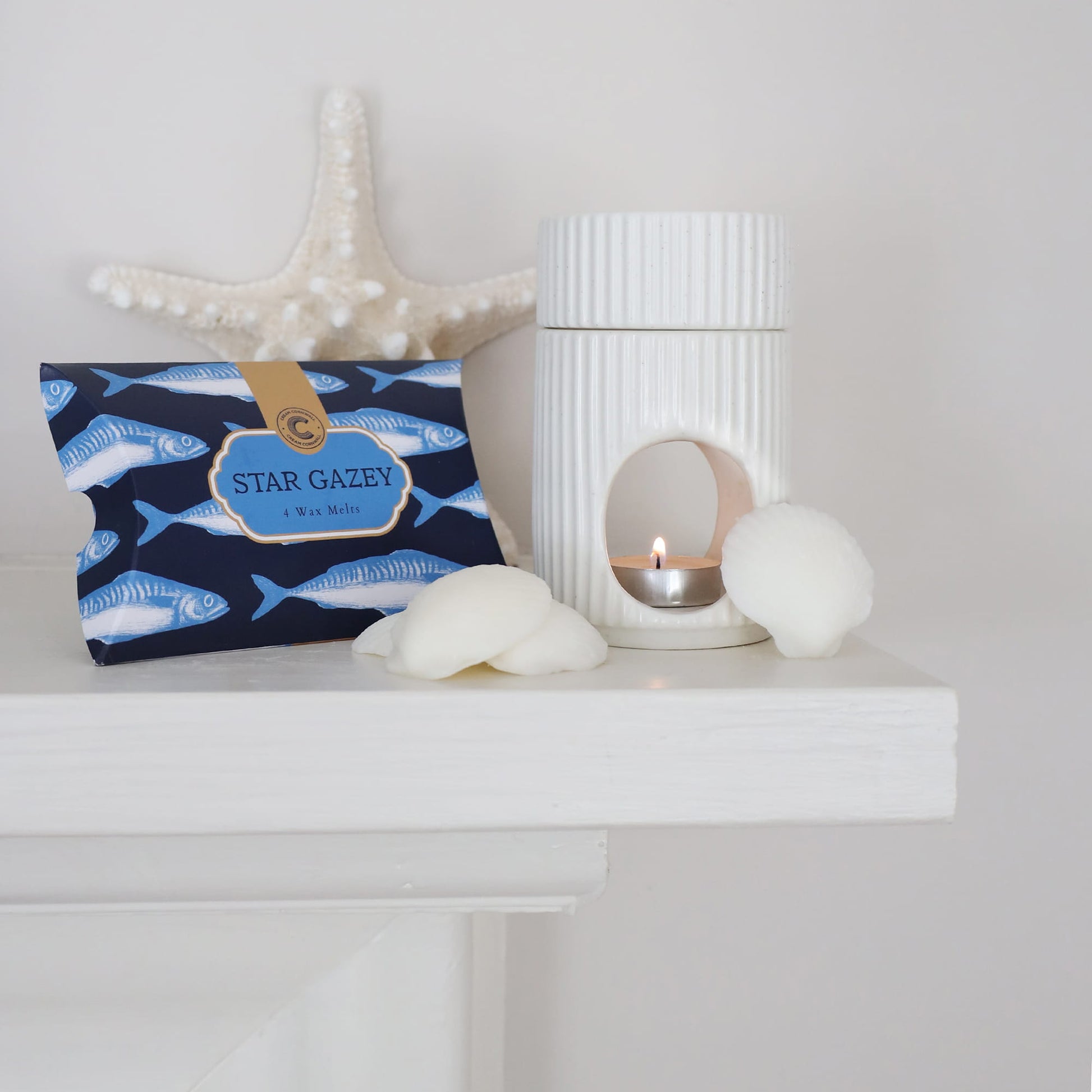 Nautical-themed pouch with starfish design on a white surface with decorative items.