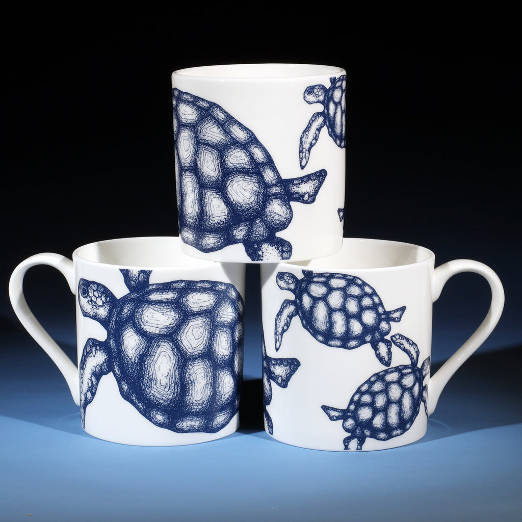 Stack of three Turtle mugs showing all sides of the mug.