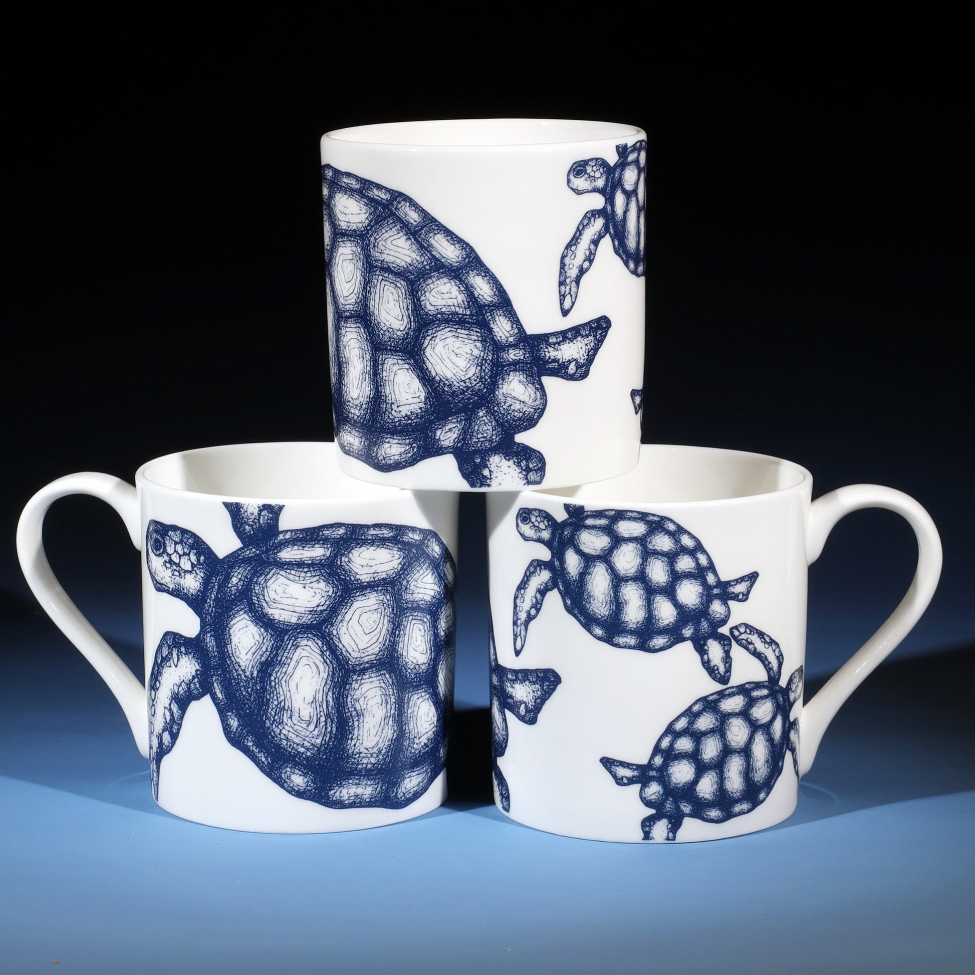 Stack of three Turtle mugs showing all sides of the mug.