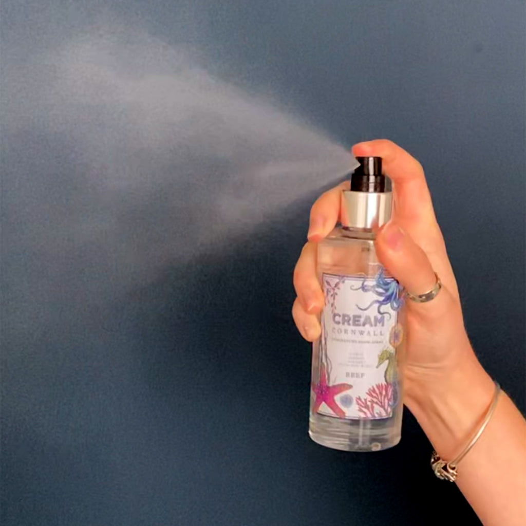 Fragrance Room Spray glass bottle with atomiser top,Reef logo on label actively being squirted