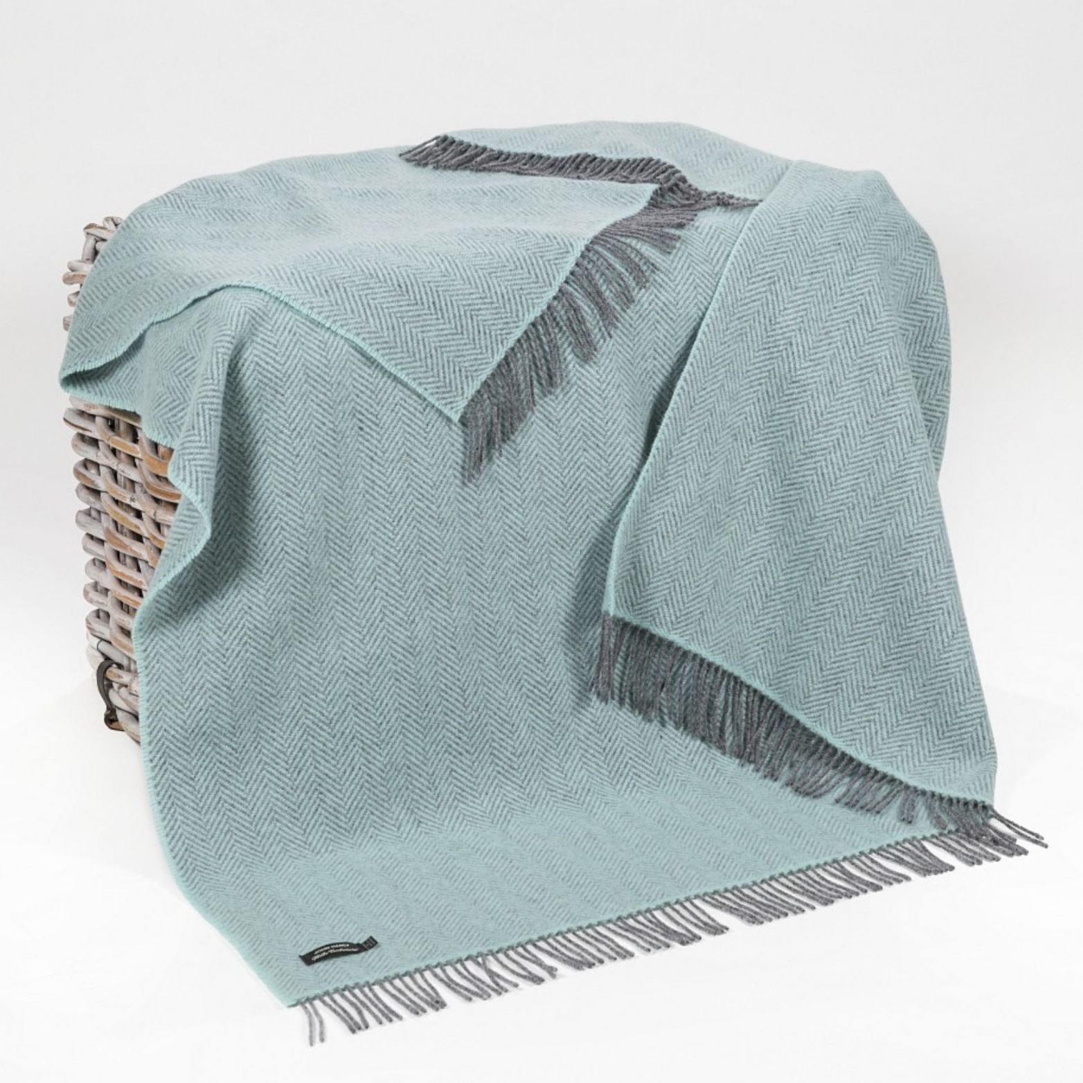 Cashmere Throw Duck Egg Herringbone draped over a basket