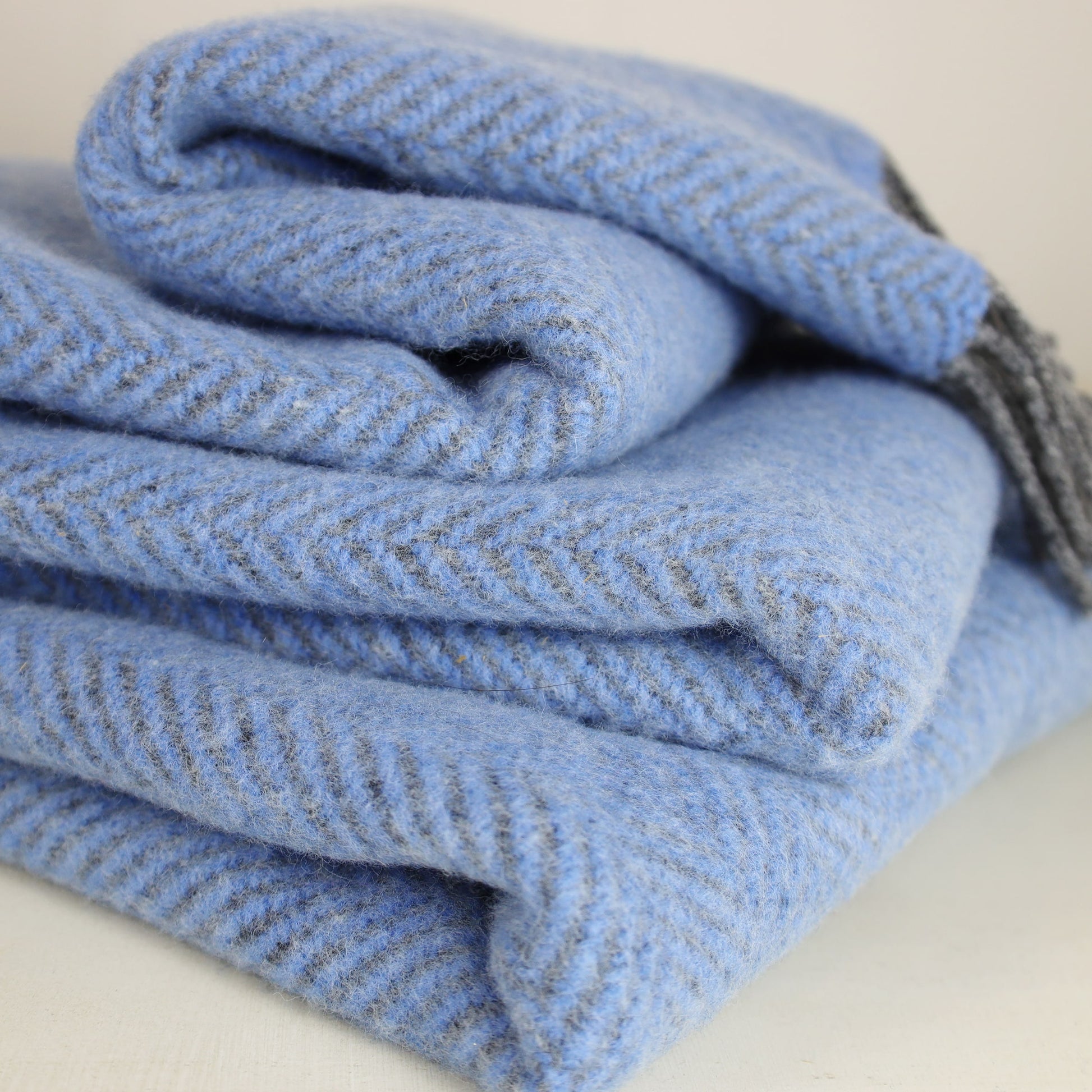 Close up of a Cashmere Throw in Grey Blue Herringbone 