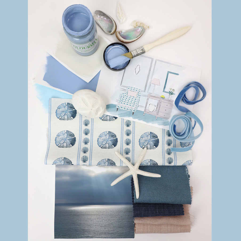 Coastal-themed mood board with soft blue and neutral tones. Includes a striped sand dollar fabric, paint swatches, shells, a starfish, fabric samples, and an interior sketch of a seaside-style room.