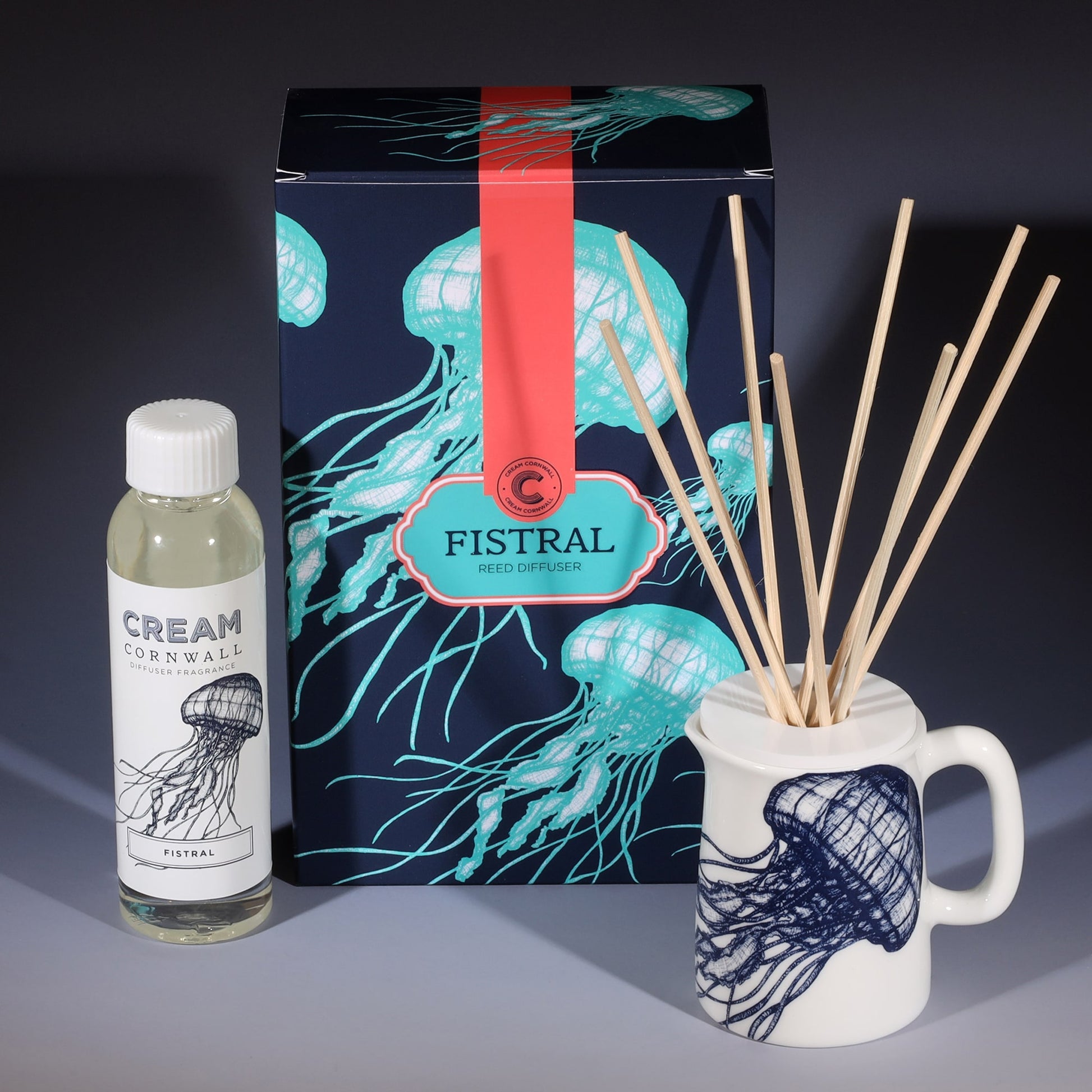 Fistral room diffuser with natural reeds in front of the product box and a bottle of diffuser liquid.