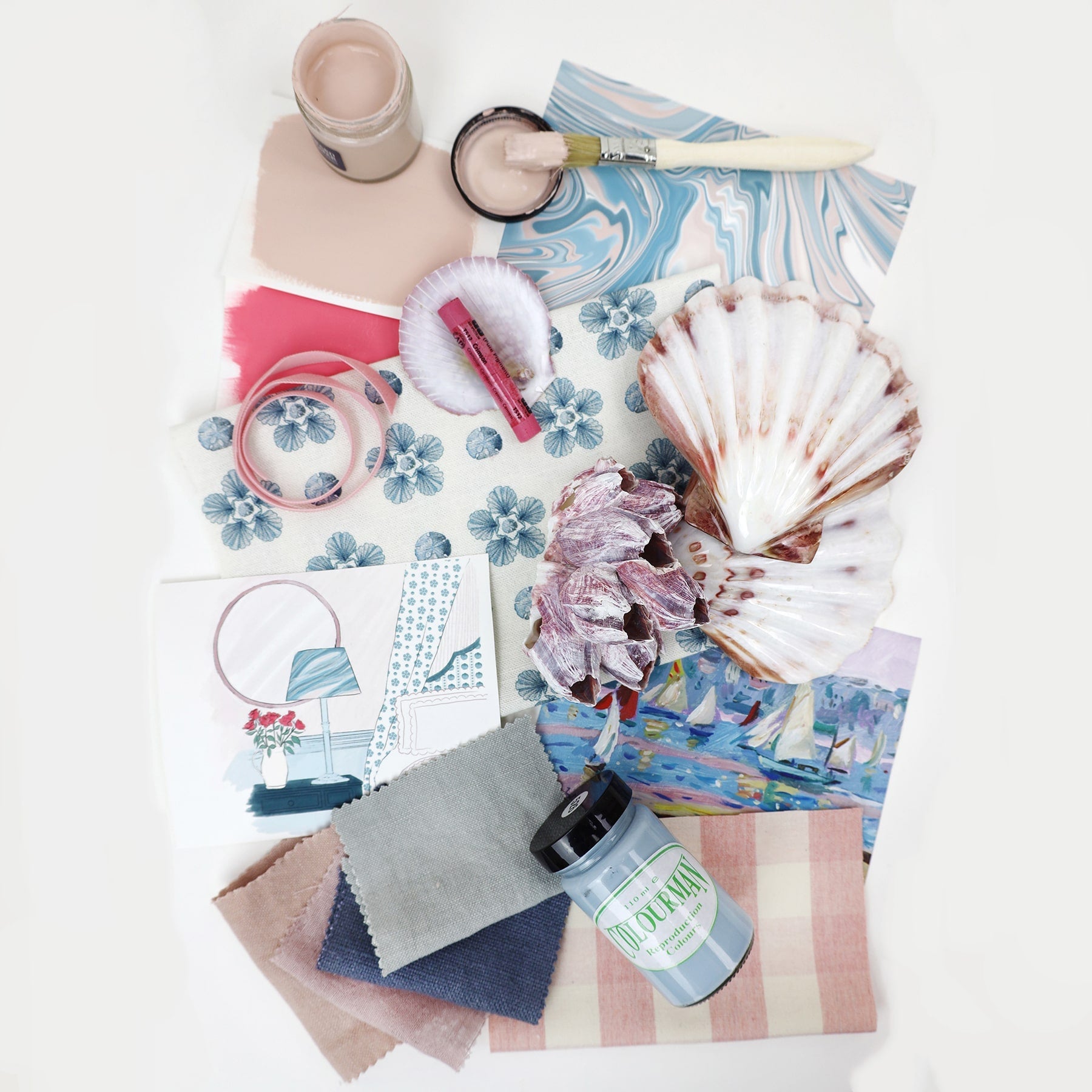 A mood board showcasing a coastal-inspired interior design scheme with blue sand dollar flower fabric, pink and blue paint samples, a marbled wallpaper swatch, sea shells, ribbons, fabric swatches in blush, denim, and taupe, a pink crayon in a shell, a paintbrush with blush paint, and a small illustrated room scene.