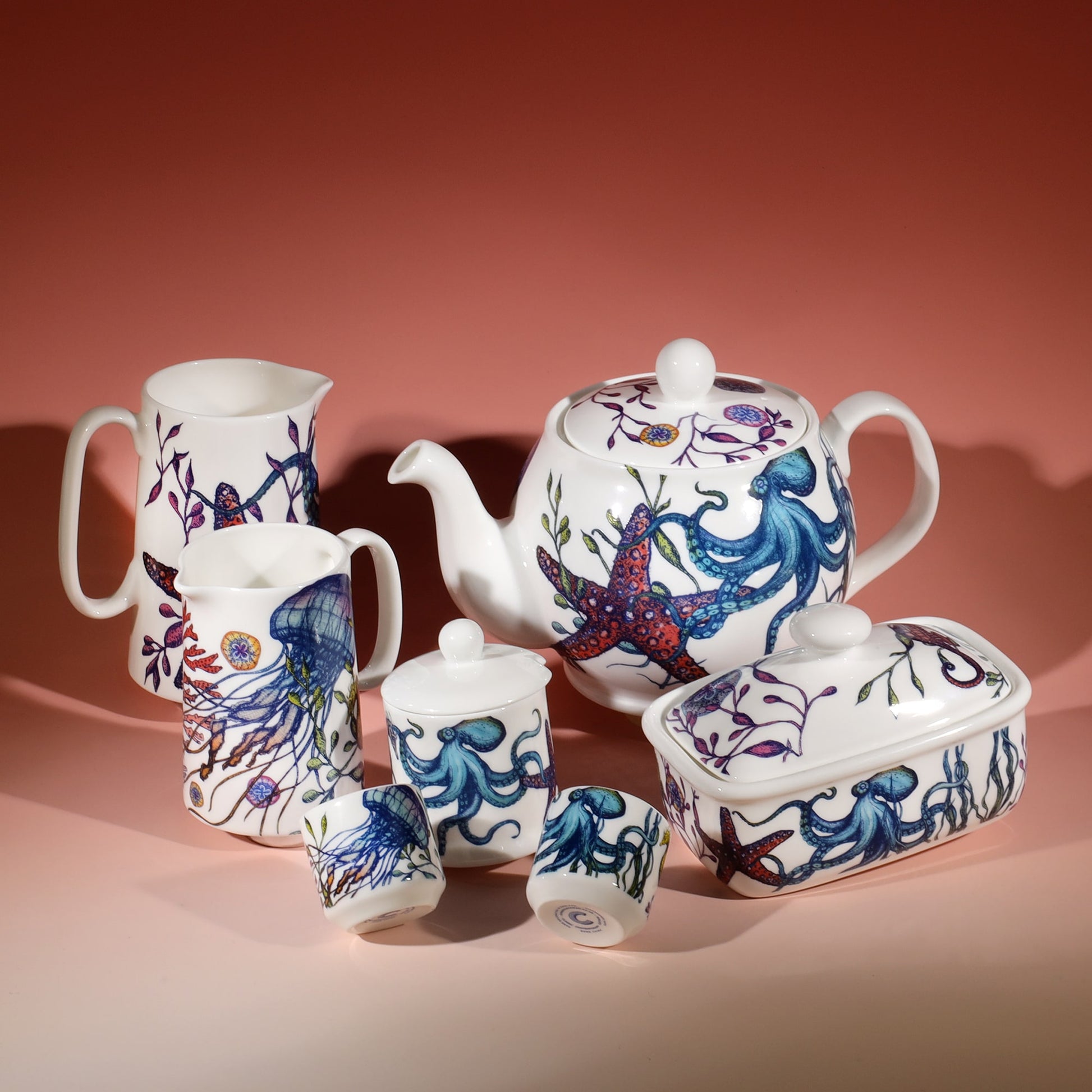 Butter dish in our brightly coloured Reef range,with Octopus,seaweed,seahorses and other sea themed designs all over the base and the lid.Next to this are the matching Reef Egg cups,Jam Pots,Teapot and two sizes of jugs.