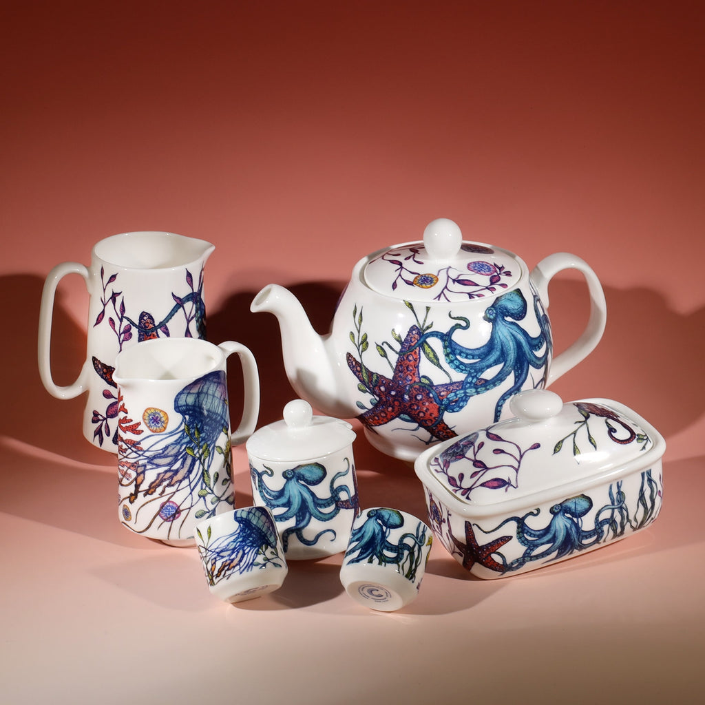 Jam Pot with lid in our bright coloured Reef range with a space in the lid for a tea spoon.Next to this are matching Reef Egg cups,a butterdish,teapot and a couple of Reef Jugs