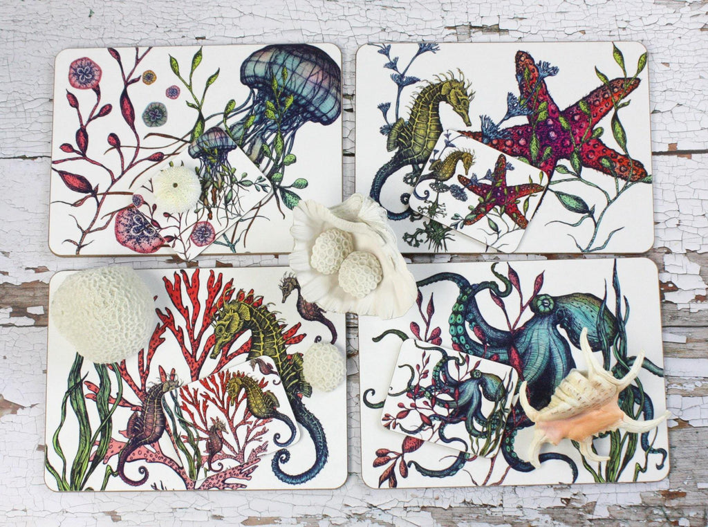 Set of four different coasters in our Reef coloured design with an Octopus,Seahorse,Jellyfish and a Starfish design with matching Placemats.All placed on a table decorated with various shells.