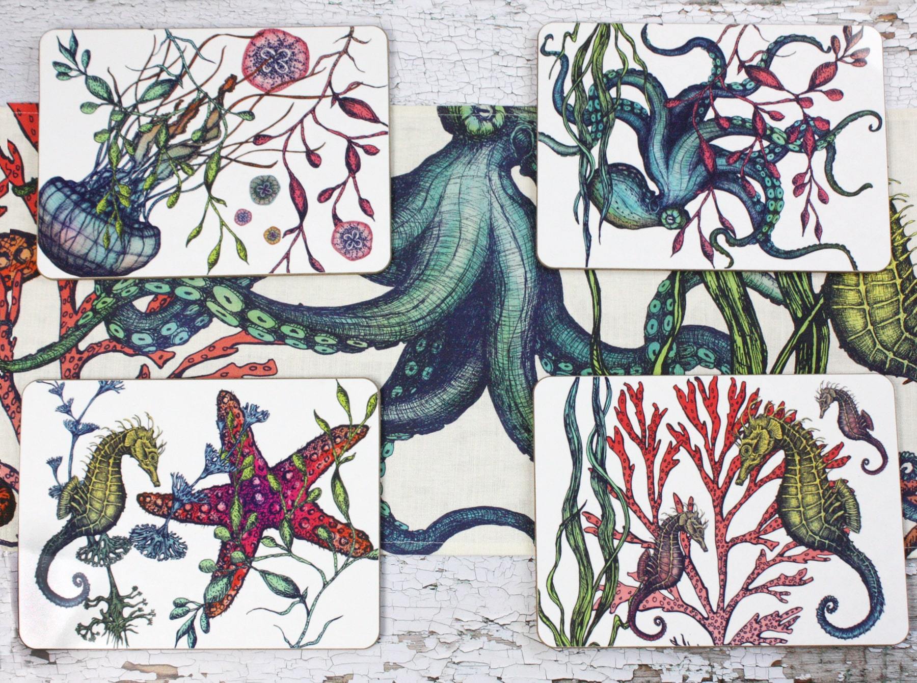Set of four different coasters in our Reef coloured design with an Octopus,Seahorse,Jellyfish and a Starfish design with matching Placemats.All placed on a table on a matching table runner.