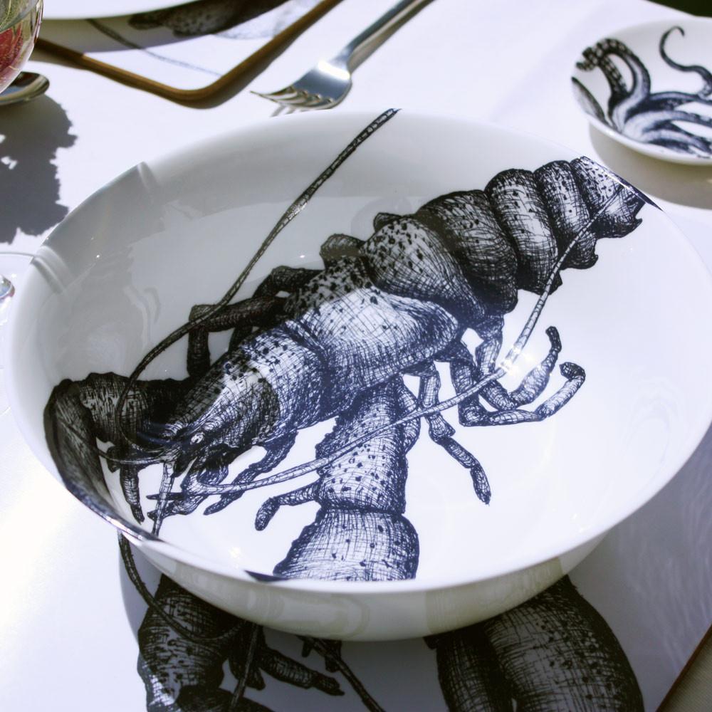 Serving bowl in Bone China in our Classic range in Navy and white in the Lobster design on a white tablecloth.On the table are other pieces of Cream tableware