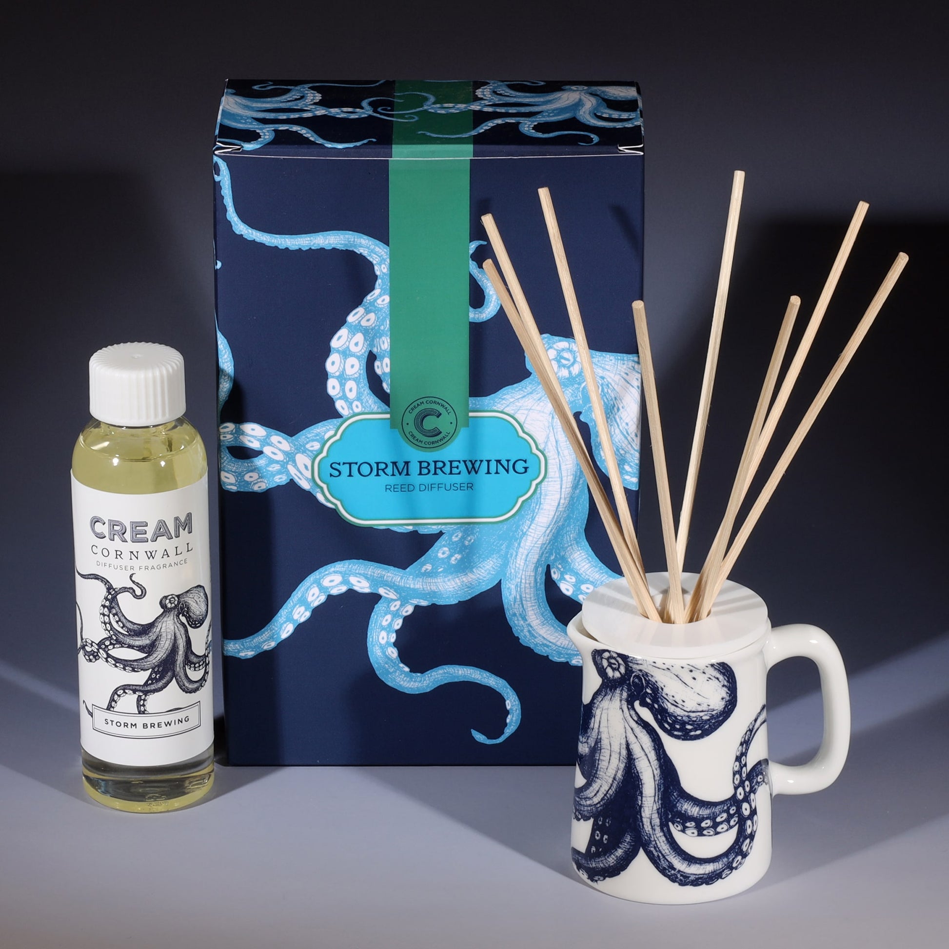 Storm Brewing room diffuser with natural reeds in front of the product box and a bottle of diffuser liquid.